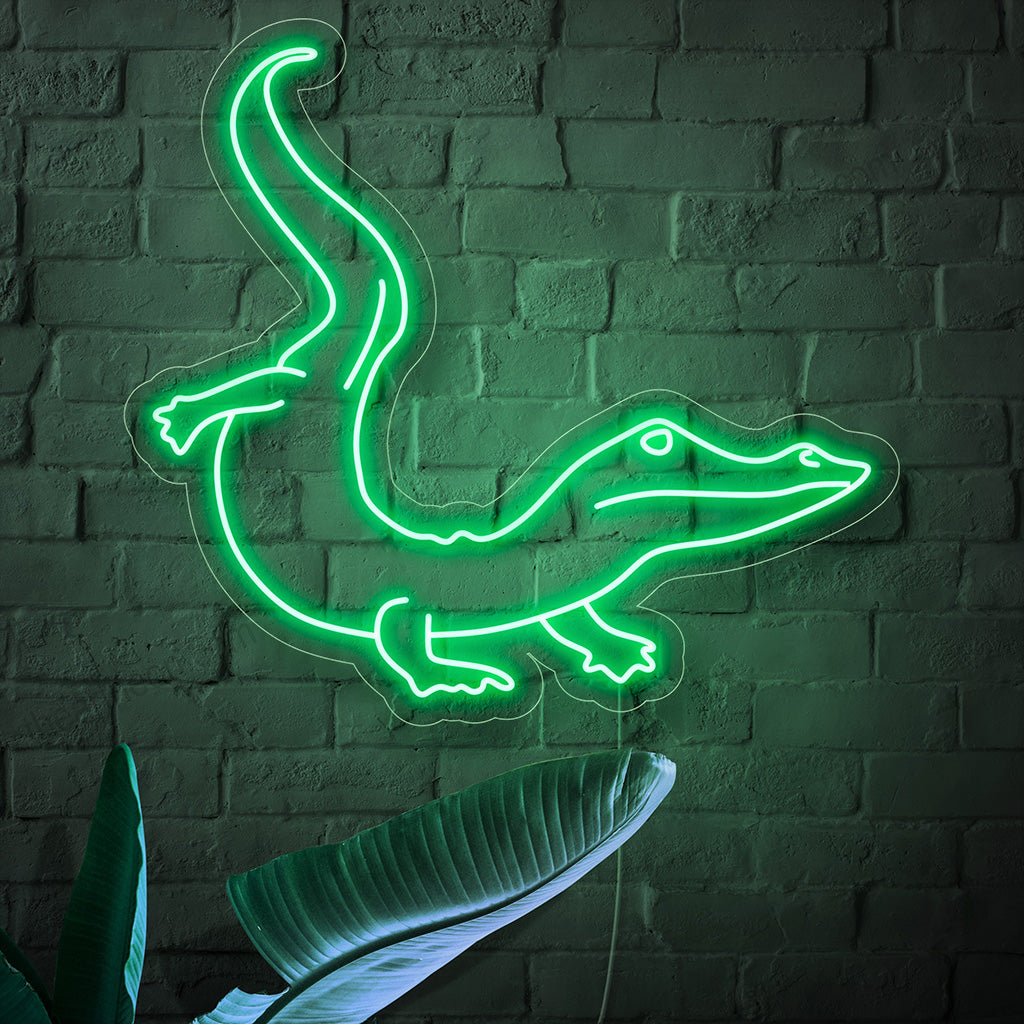 "Crocodile Neon Sign" ��� Ett djärvt och exotiskt neonljus som visar upp siluetten av en krokodil, som ger ditt utrymme stark energi och äventyrlig charm.