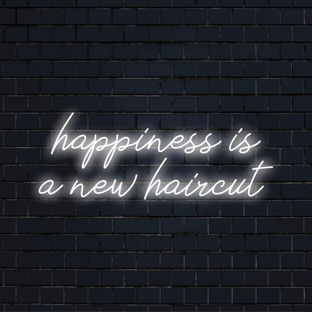 Ljus, elegant anpassad LED-neonskylt som anger Happiness Is A New Haircut, perfekt för modern inredning.