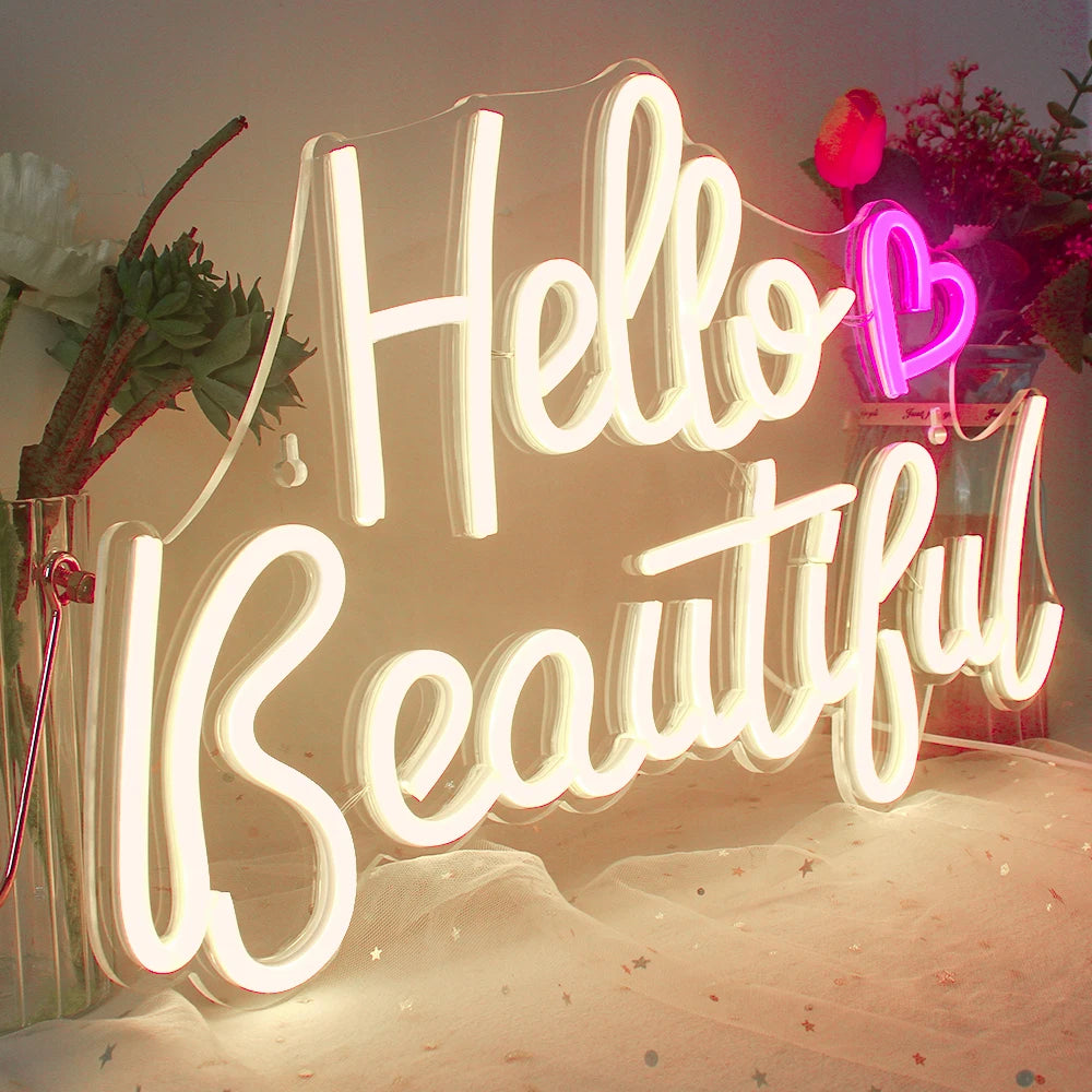 Bilden har en levande, iögonfallande "Hello Beautiful" LED-neonskylt.
