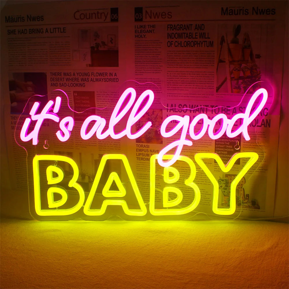 Bilden har en livfull "It's All Good Baby" LED-neonskylt, tillverkad i ett elegant, modernt manustypsnitt.