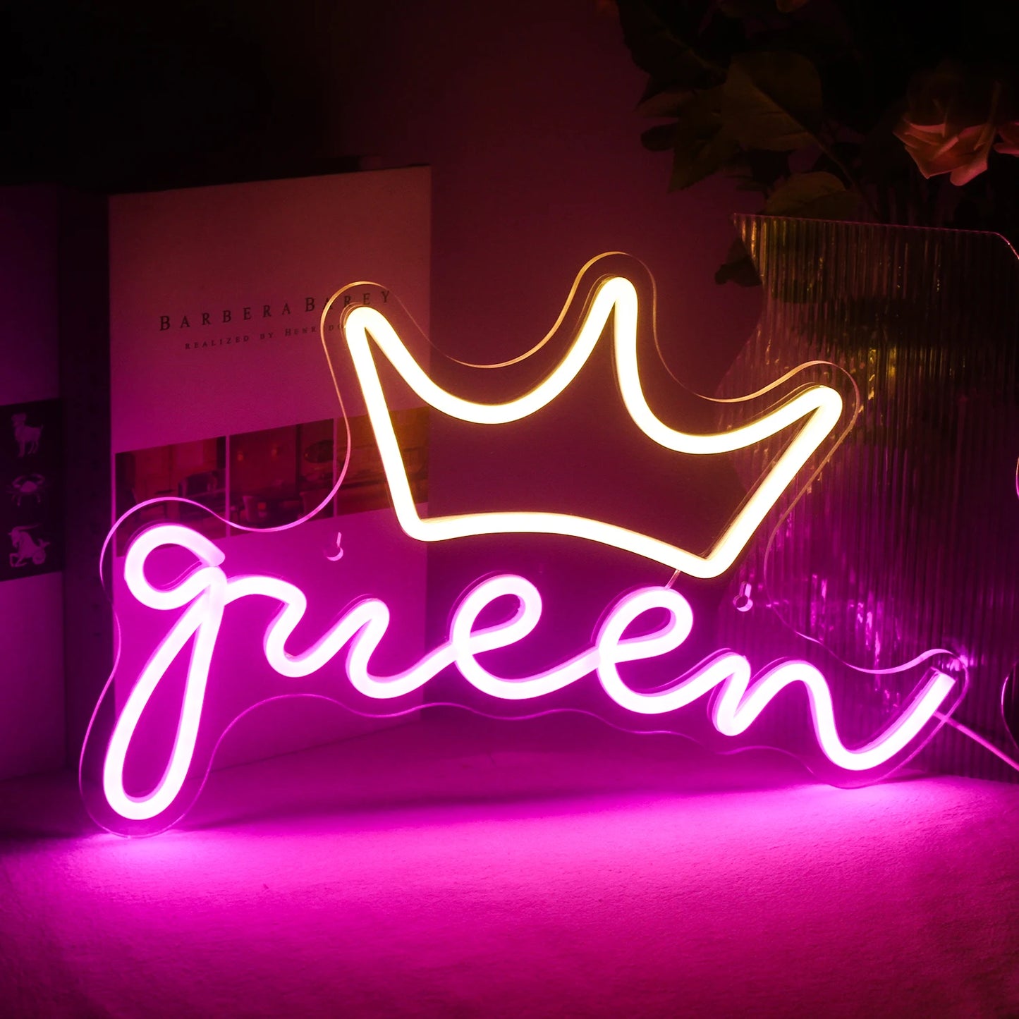 En livlig LED-neonskylt i form av ordet "Queen" visas.