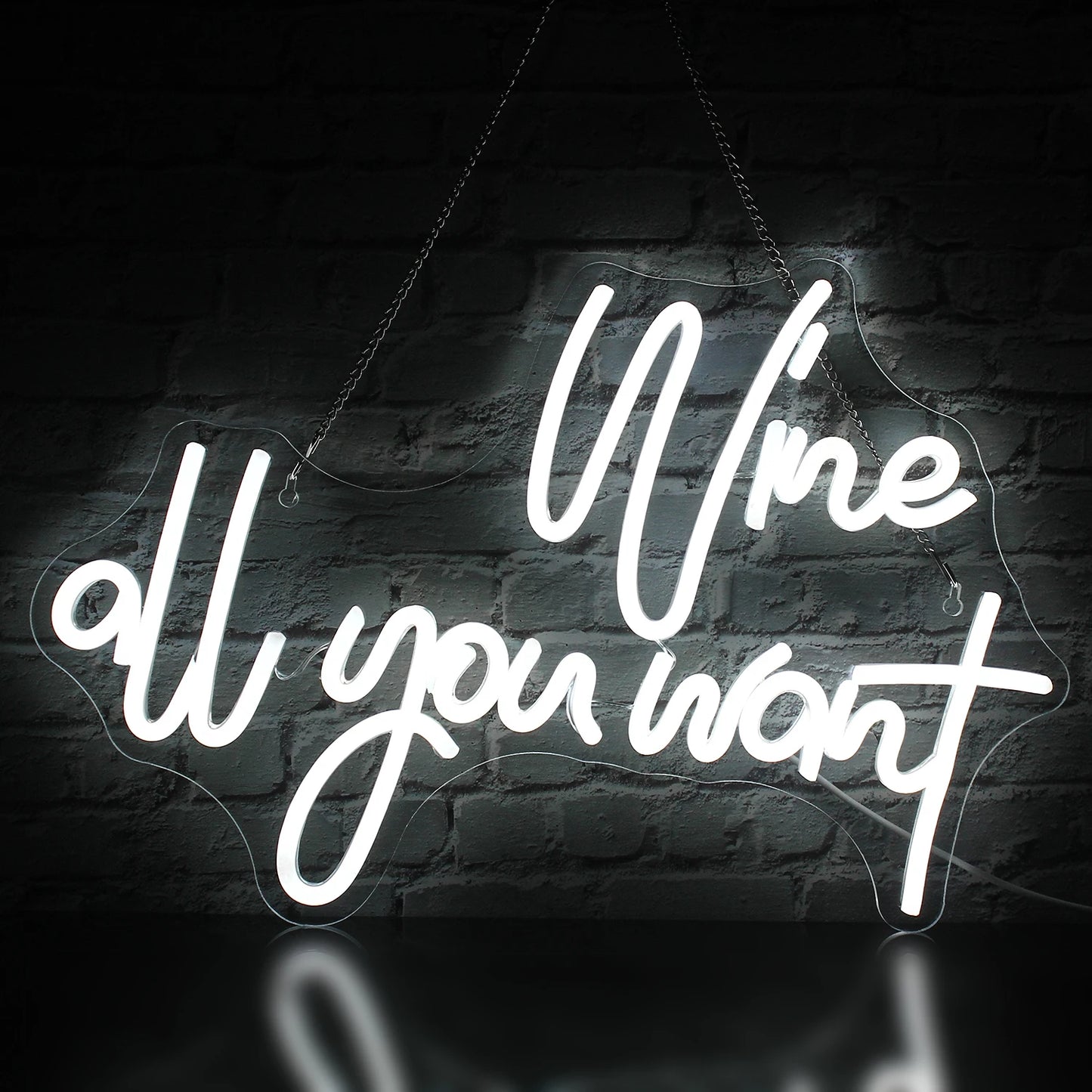 Bilden visar en levande LED-neonskylt som läser "Wine all you want" med eleganta kursiva bokstäver.