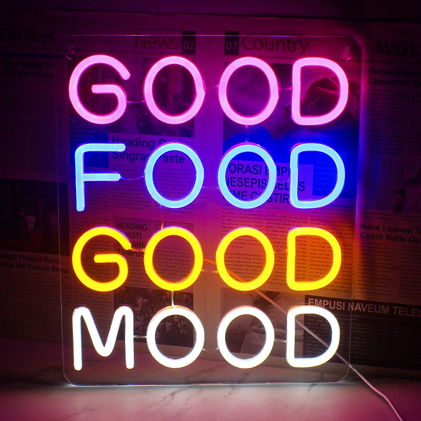 En livlig LED-neonskylt som visar orden "Good Food Good Mood" i ett lekfullt, kursivt teckensnitt.