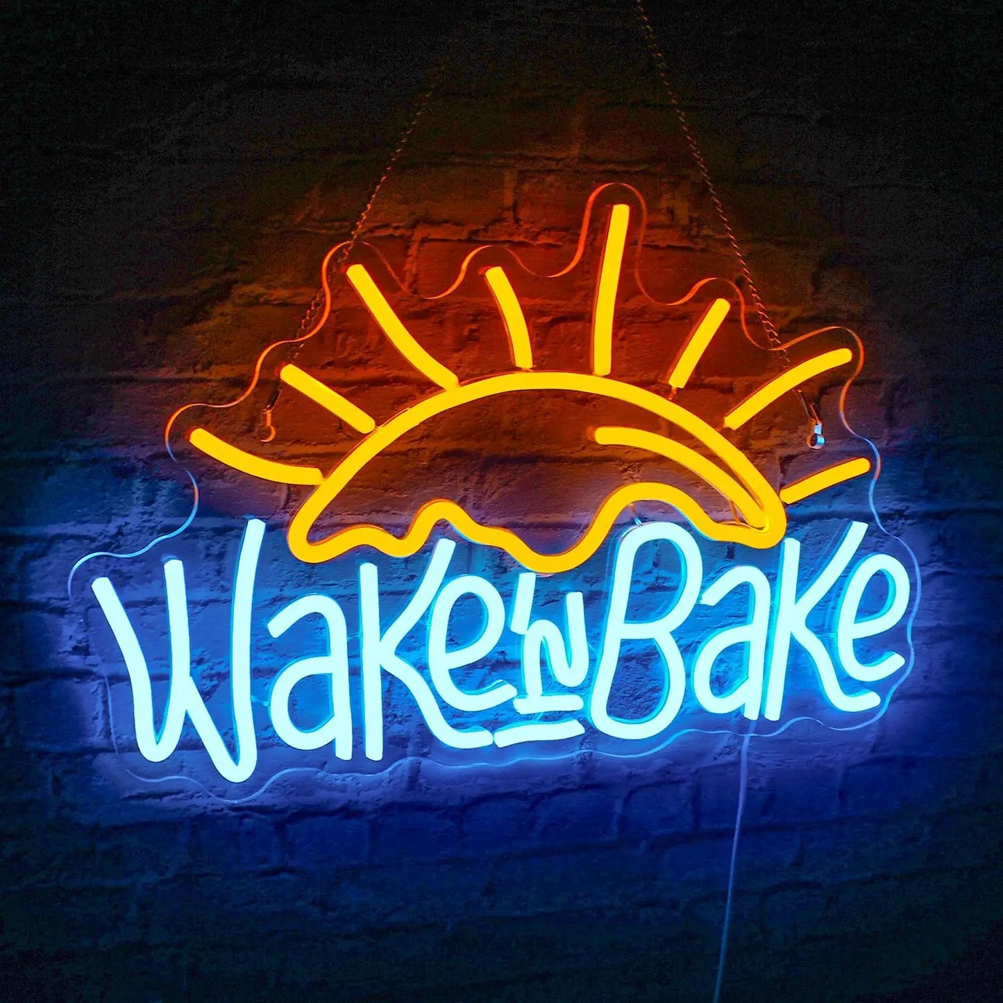 Bilden visar en levande, handgjord LED-neonskylt med den lekfulla texten "Wake n' Bake" i elegant, kursivt teckensnitt.