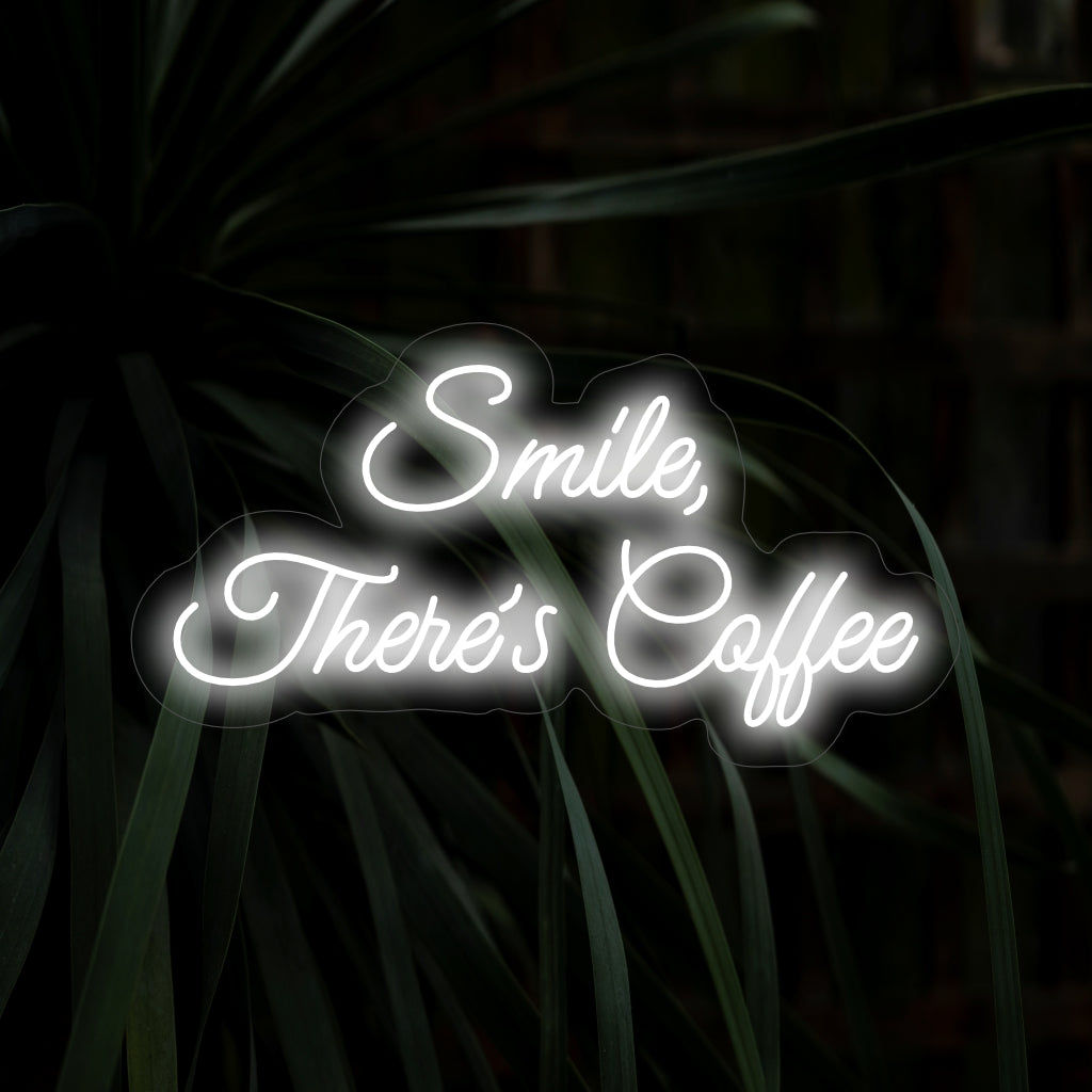 "Smile, There's Coffee Neon Sign" sprider jubel med sitt upplyftande budskap och kaffekoppsdesign, som kastar ett härligt sken för en positiv och varm atmosfär i ditt utrymme.