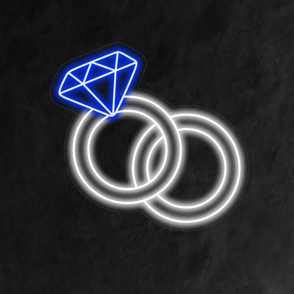 "Wedding Rings Neon Sign" symboliserar evig kärlek med ett mjukt sken, vilket skapar en romantisk atmosfär som firar föreningen av två hjärtan.