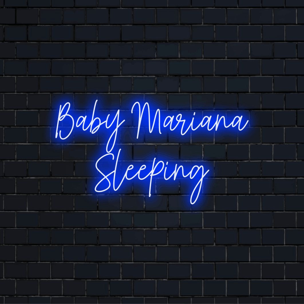 Baby Mariana Sleeping Custom Name Neon Sign, bright neon glow against black brick wall