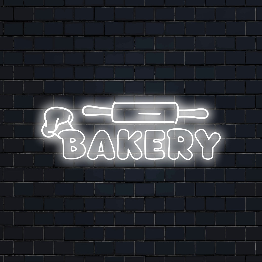 Bakery Rolling Pin Neon Sign, glowing neon text on dark brick wall