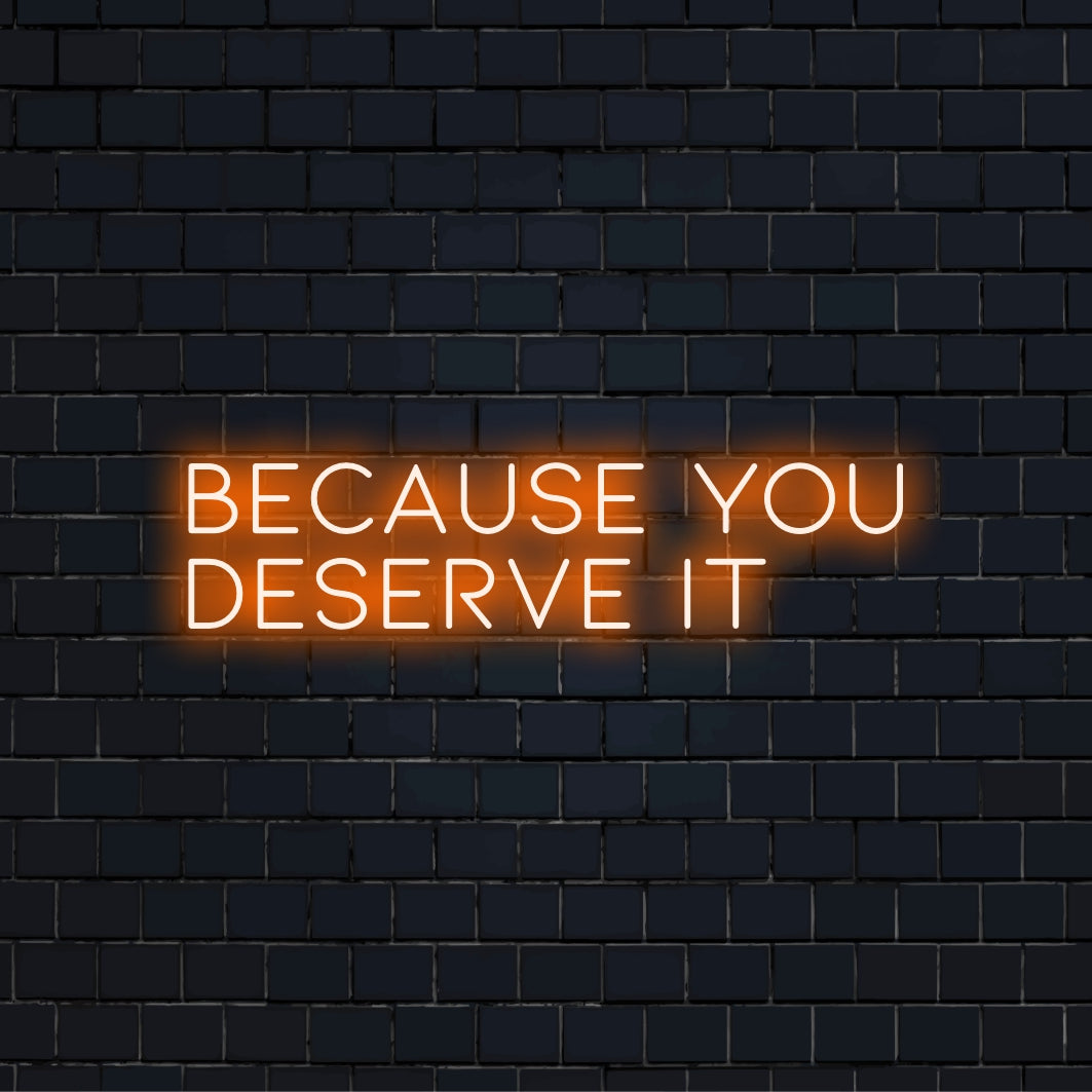 Because You Deserve It LED Neon Sign, glowing wall decor on dark brick background