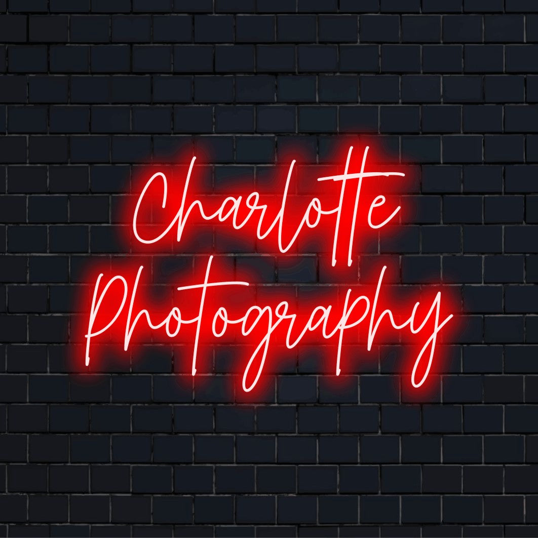 Charlotte Photography Personalized LED Neon Sign, soft neon glow against black brick wall
