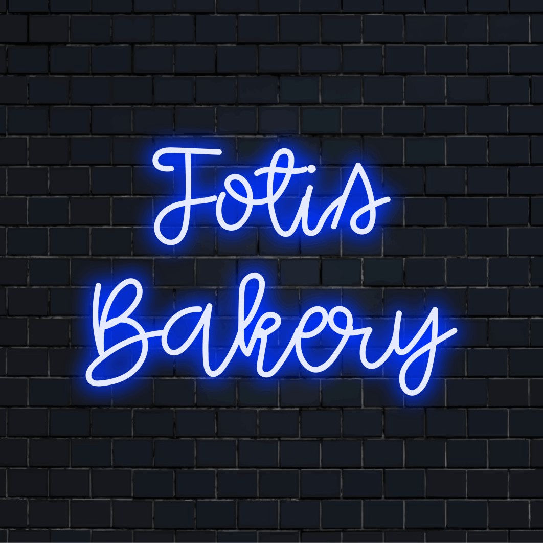 Fotis Bakery Personalized LED Neon Sign, bright neon lettering against black brick wall