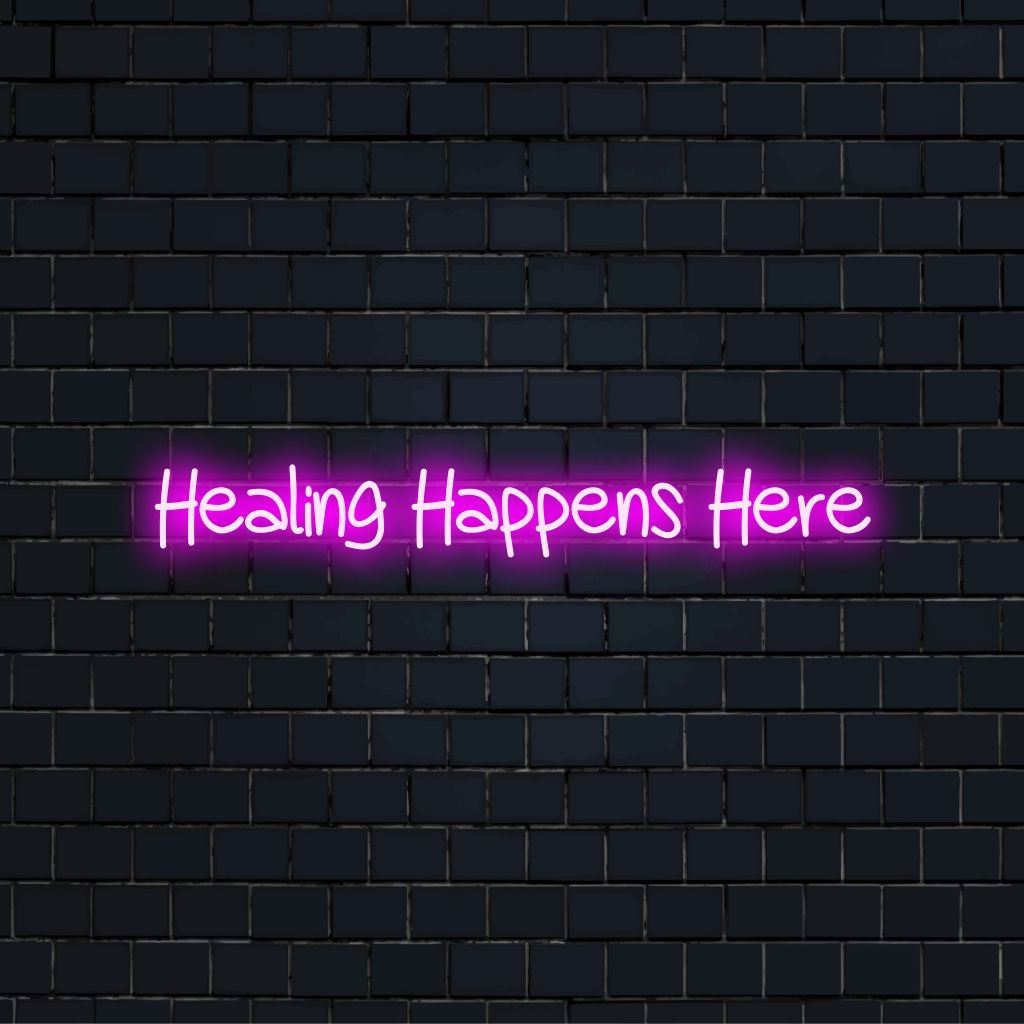 Healing Happens Here LED Neon Sign, neon text light against brick backdrop