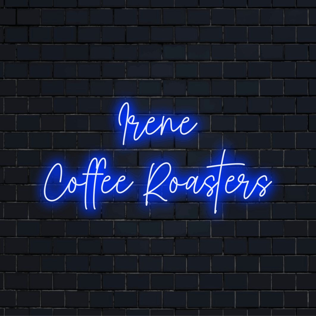 Irene Coffee Roasters Personalized Neon Light with glowing lettering on dark brick wall