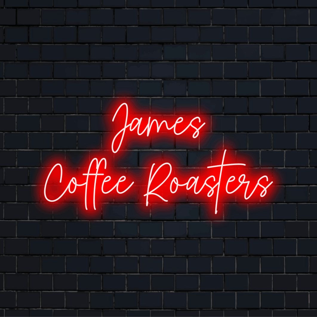 James Coffee Roasters Personalized Neon Light with neon text light against brick backdrop