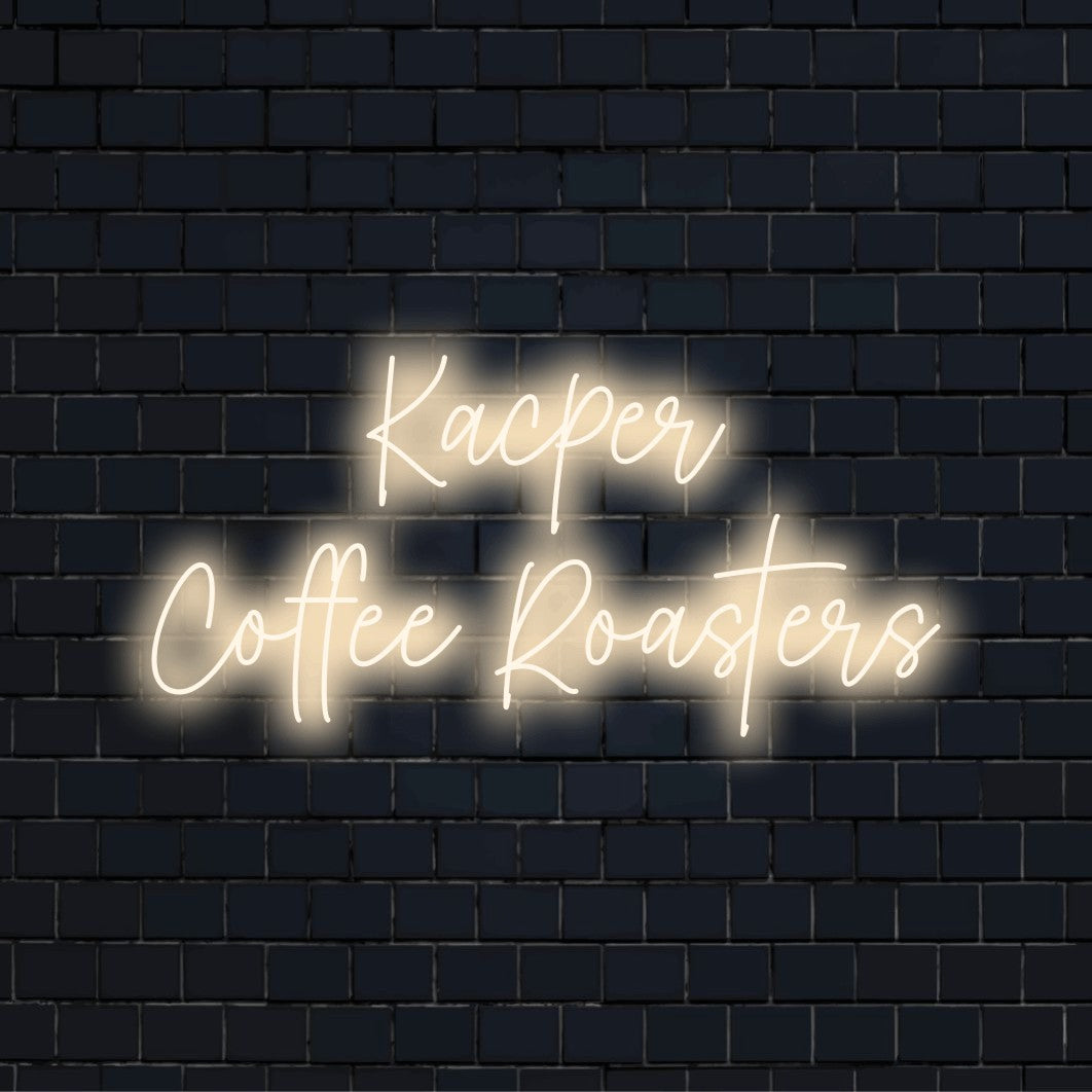 Kacper Coffee Roasters Personalized Neon Light with glowing lettering on black brick background