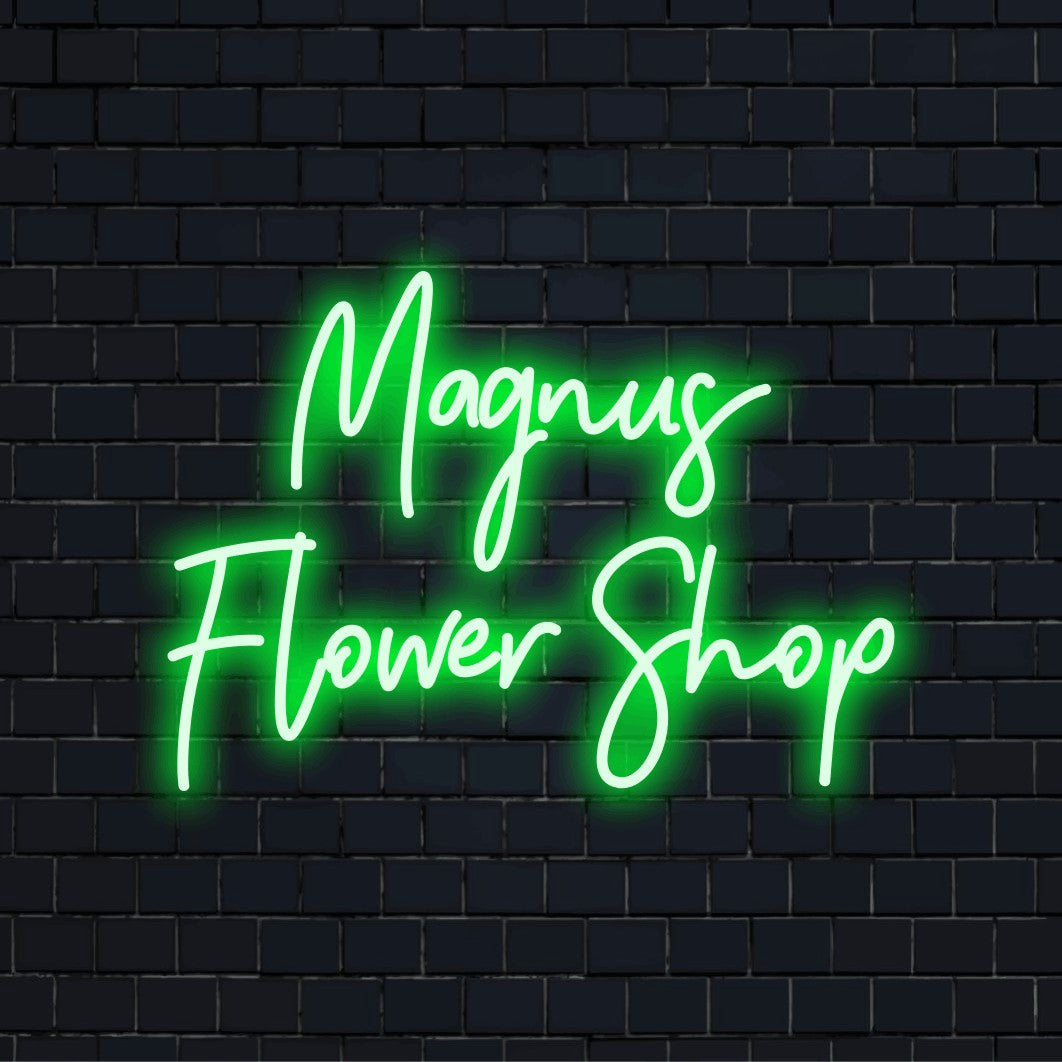 Magnus Flower Shop Custom Name Neon Sign, glowing neon text on dark brick background