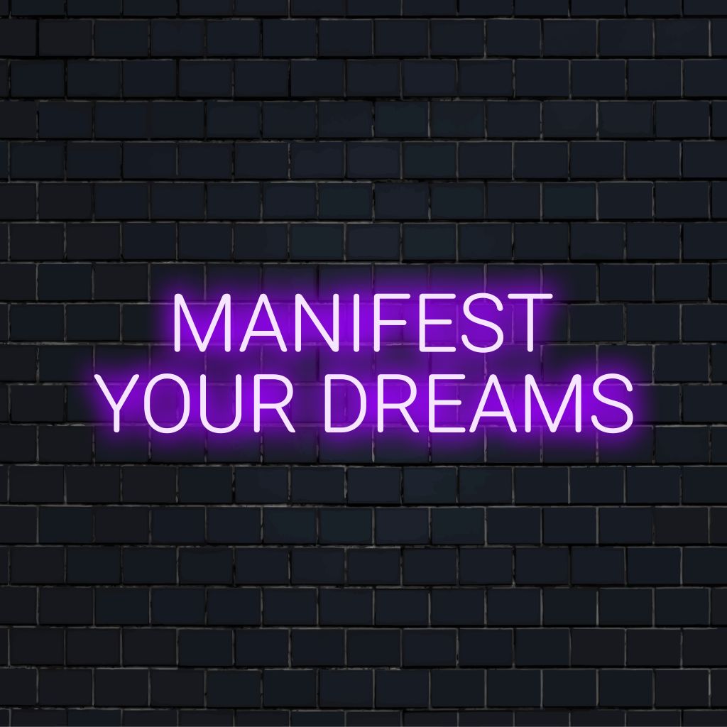 Manifest Your Dreams Neon Sign, bright neon lettering against black brick wall
