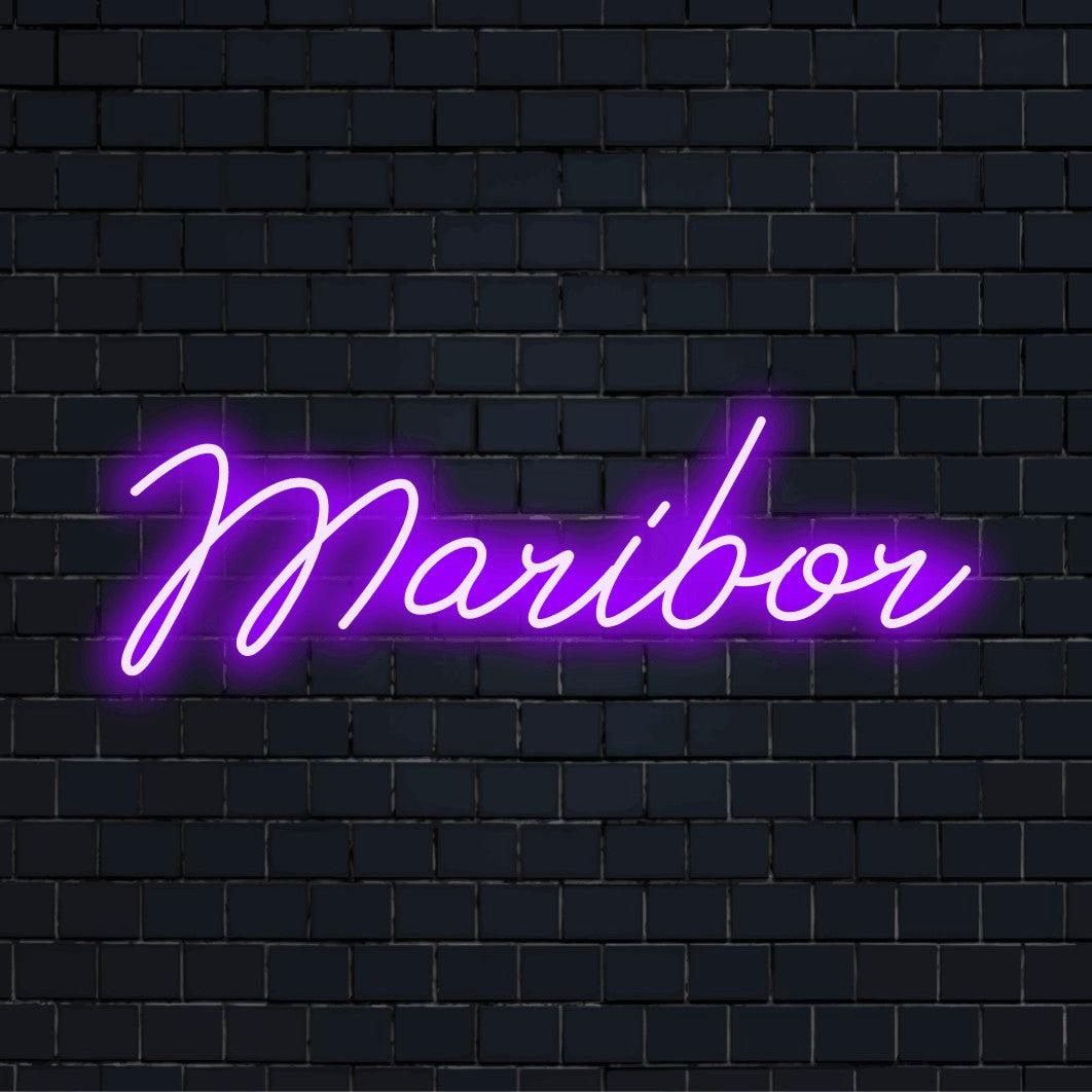 Maribor Neon Light with glowing neon text on dark brick background