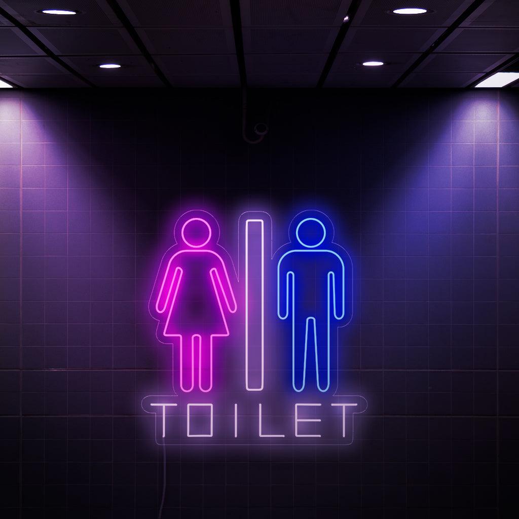 En fängslande neonskylt med en kvinna och en mansymbol, tillsammans med ordet "toalett". Denna unika skylt ger en touch av stil och funktionalitet till toaletter, vilket gör det enkelt för båda könen att hitta badrummet.
