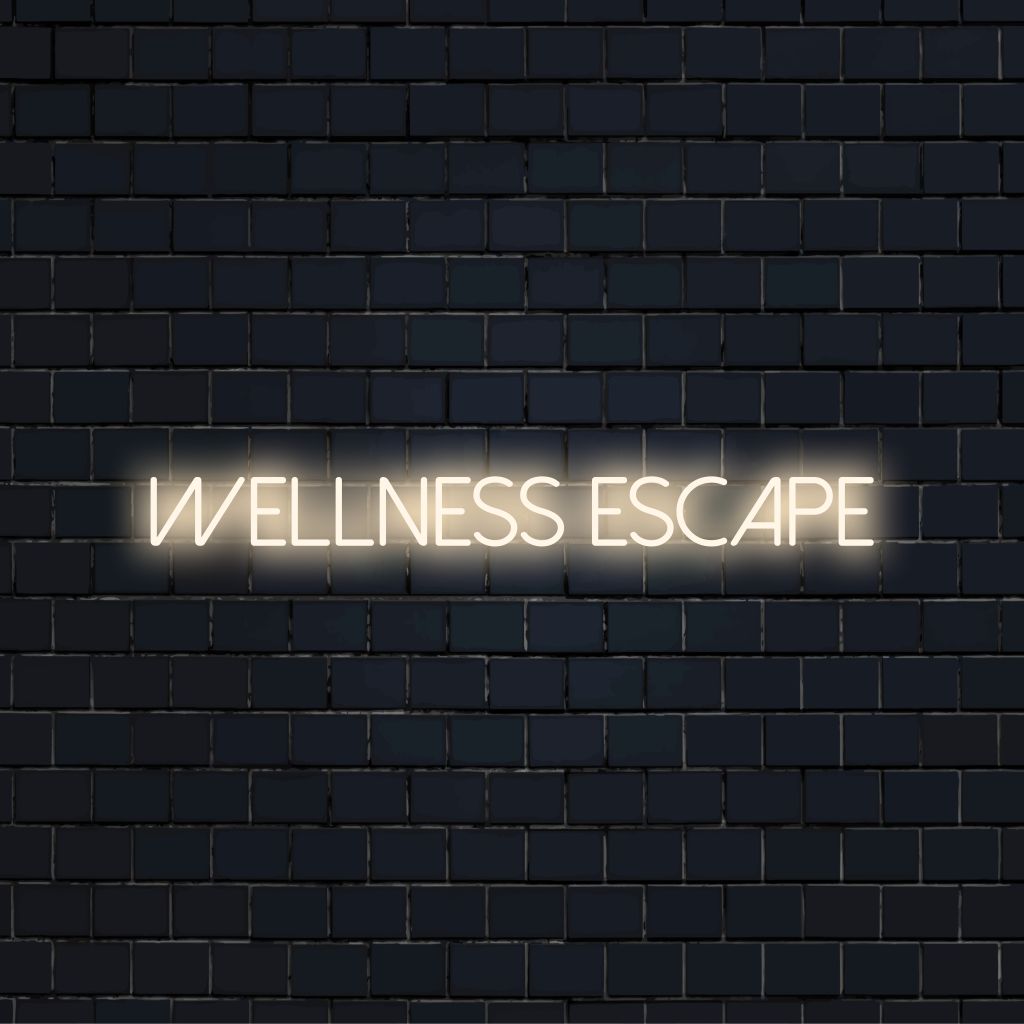 Wellness Escape Neon Sign, bright LED glow on dark brick wall