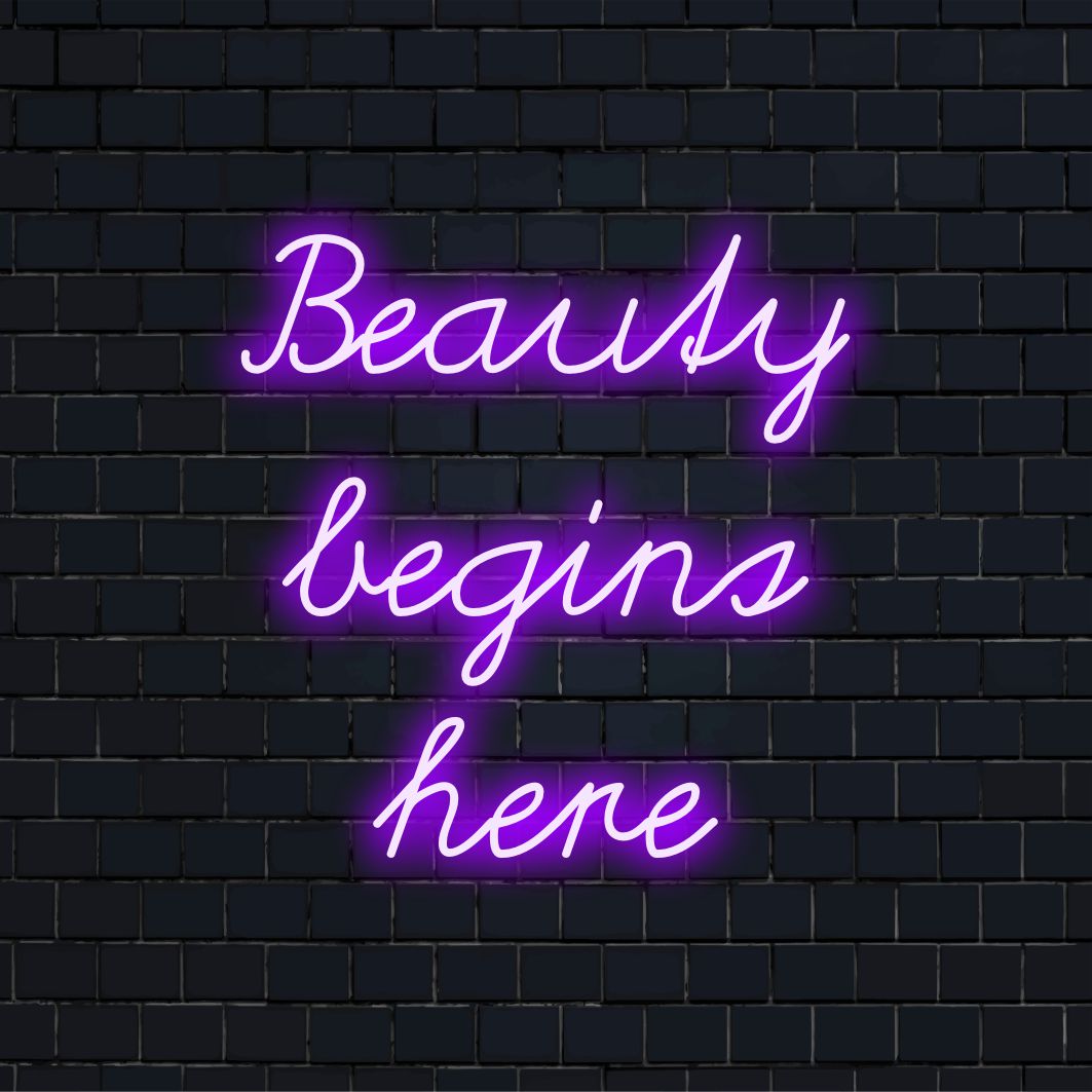 Mångsidig LED-neonskylt som läser Beauty Begins Here, som kombinerar neoncitatkonst med anpassade LED-designelement.