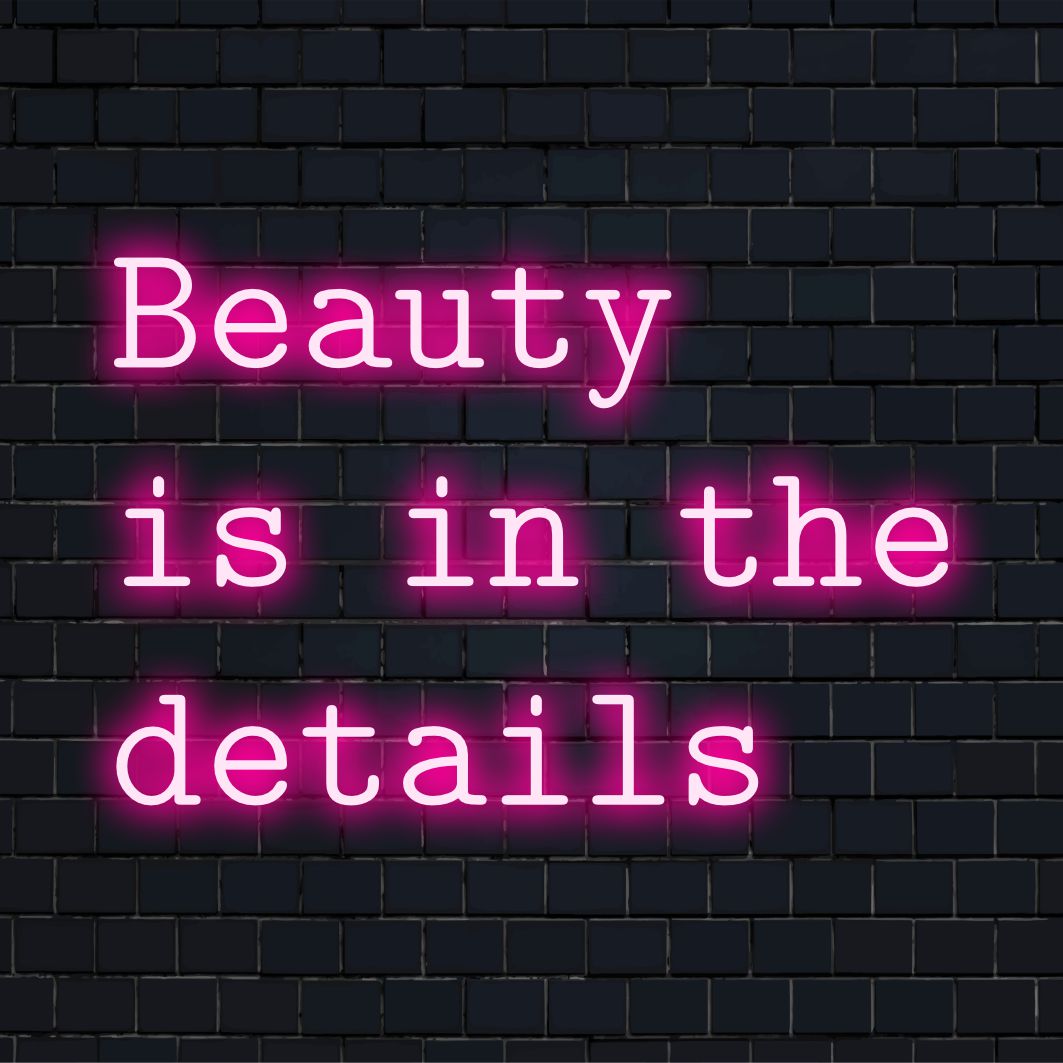 Anpassad LED-neonskylt som läser Beauty Is In The Details, perfekt för att personifiera alla utrymmen med livfull, konstnärlig stil.
