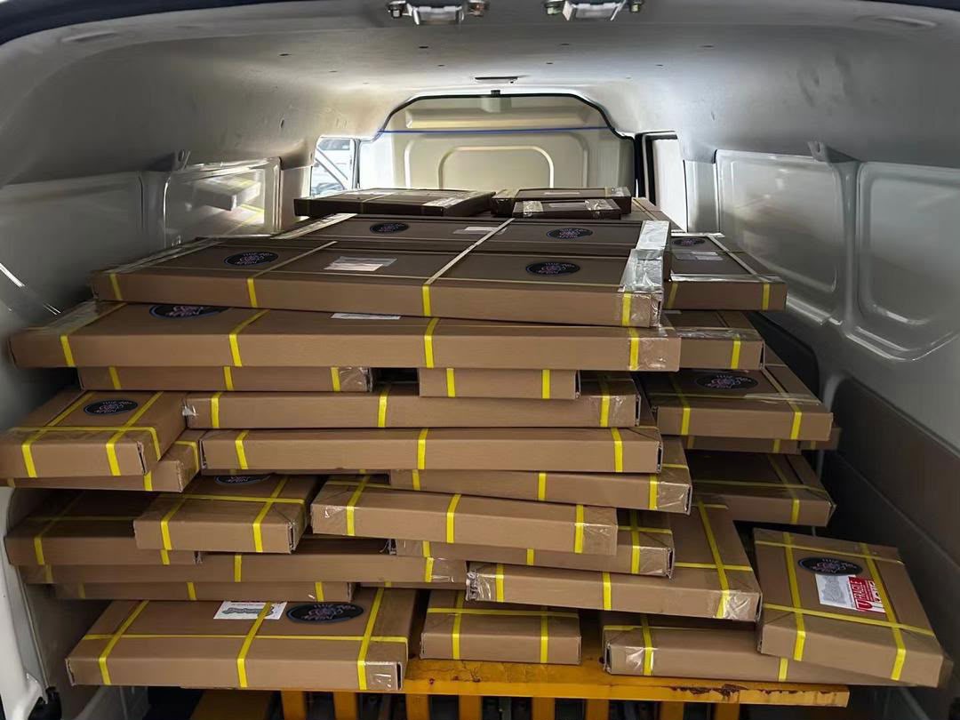 Multiple custom LED neon signs packed for a coordinated studio order