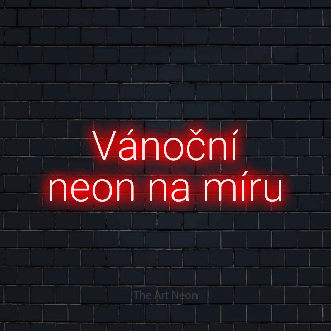 Neonový nápis na míru „Vánoční neon na míru“ na černé cihlové zdi