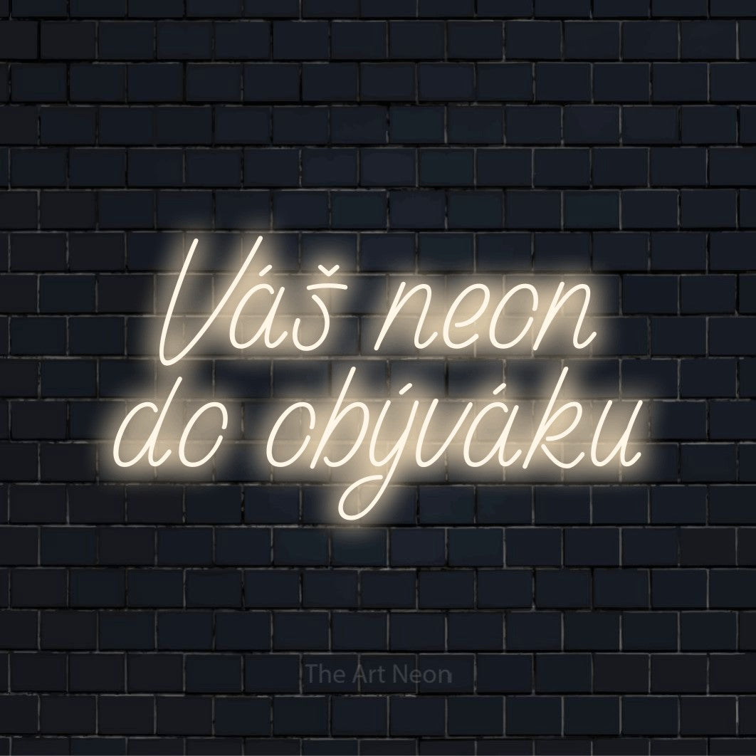 Neonový nápis na míru „Váš neon do obýváku“ na černé cihlové zdi