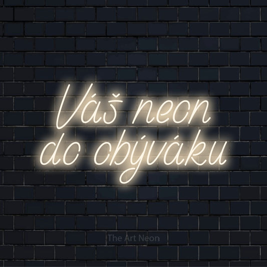 Neonový nápis na míru „Váš neon do obýváku“ na černé cihlové zdi