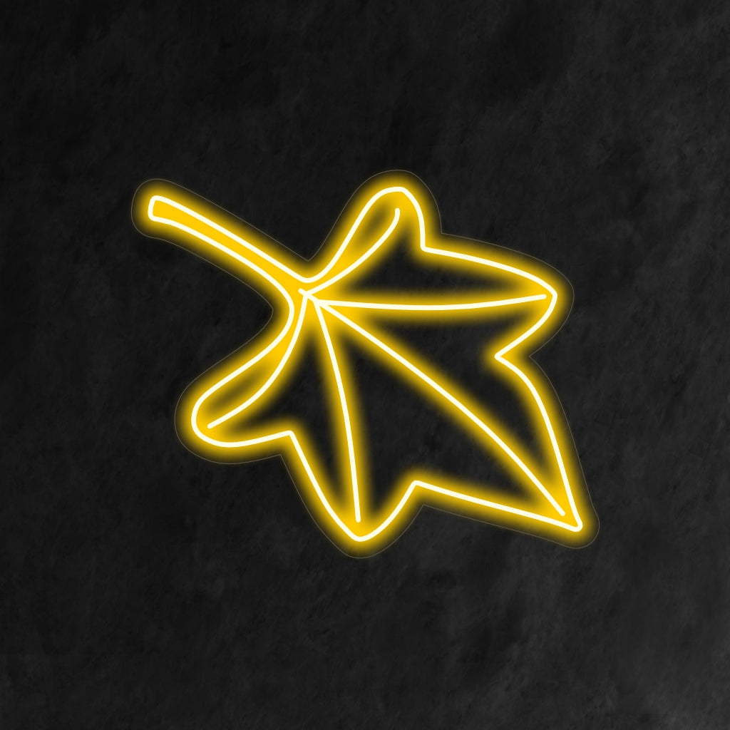 "Fall Leaf Neon Sign" lights up with warm autumn hues, perfect for seasonal decor and spaces celebrating the beauty of fall.