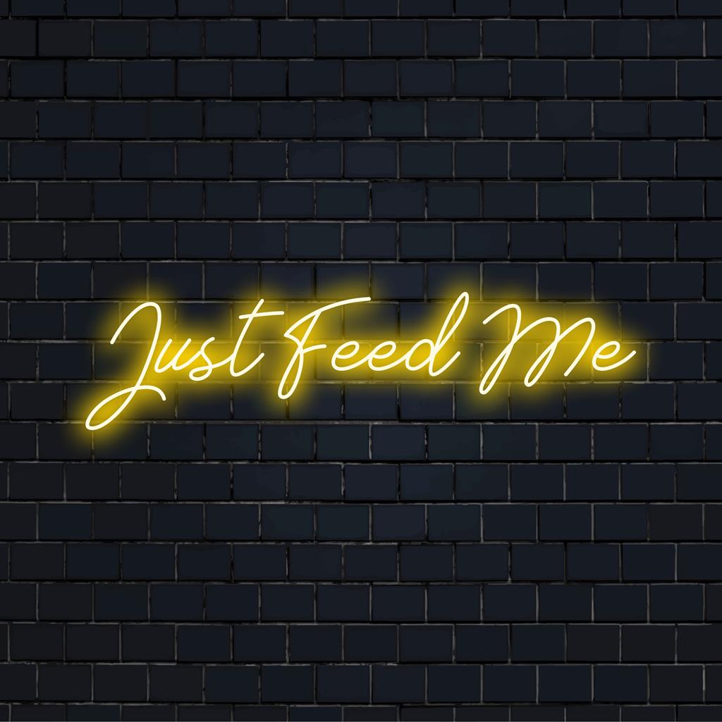 Levande LED-neonkonst med texten "Just Feed Me", perfekt för att belysa alla utrymmen med djärv, anpassad neonstil.