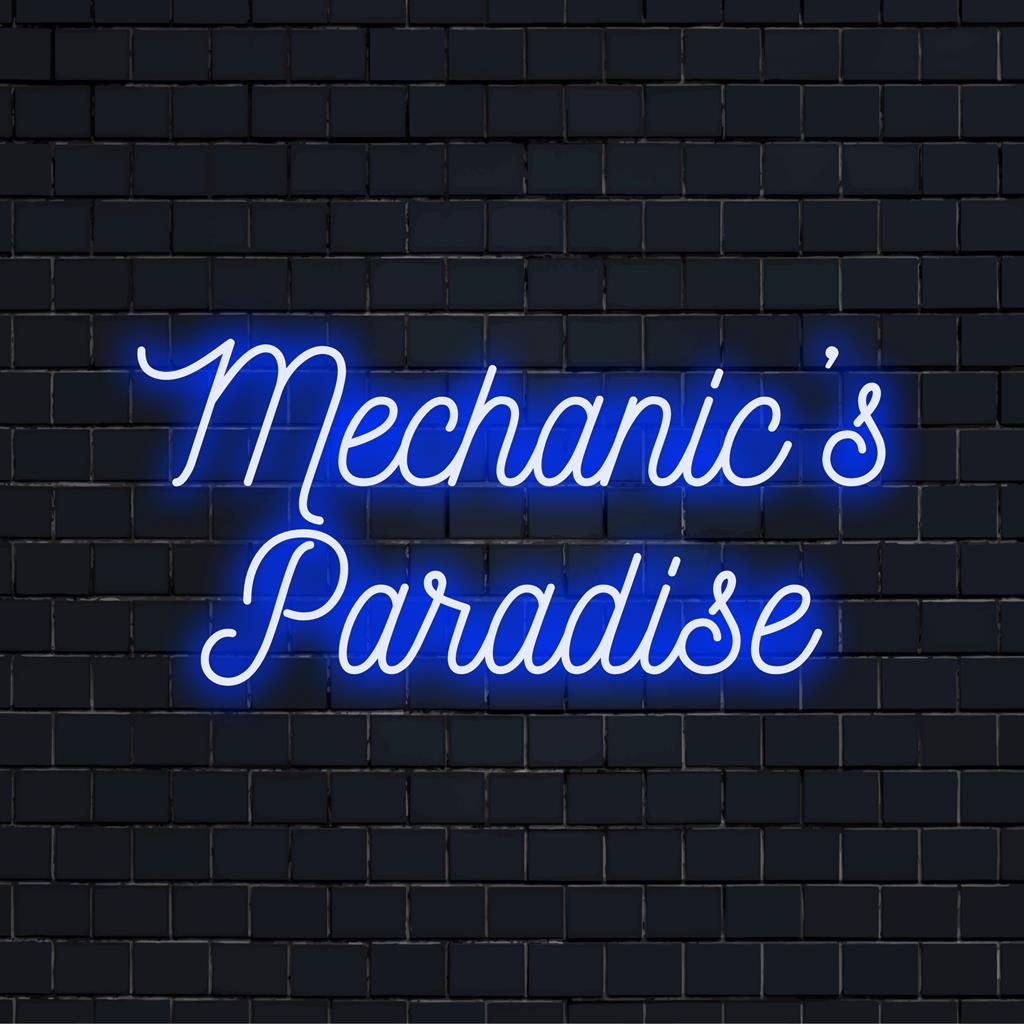 Anpassad neonskylt som läser Mechanic's Paradise i livfulla lysdioder, perfekt för personlig neondekor i en verkstadsmiljö.