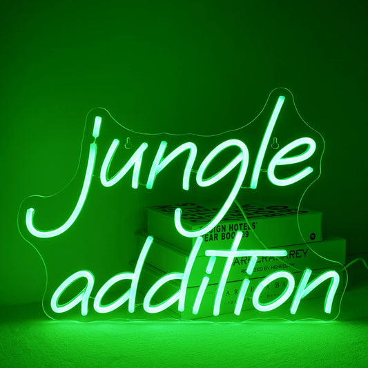 A vibrant green "Jungle Addition" LED neon sign, set against a minimalistic white wall background.