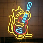"An LED neon sign features a cartoon-style cat energetically playing an electric guitar.