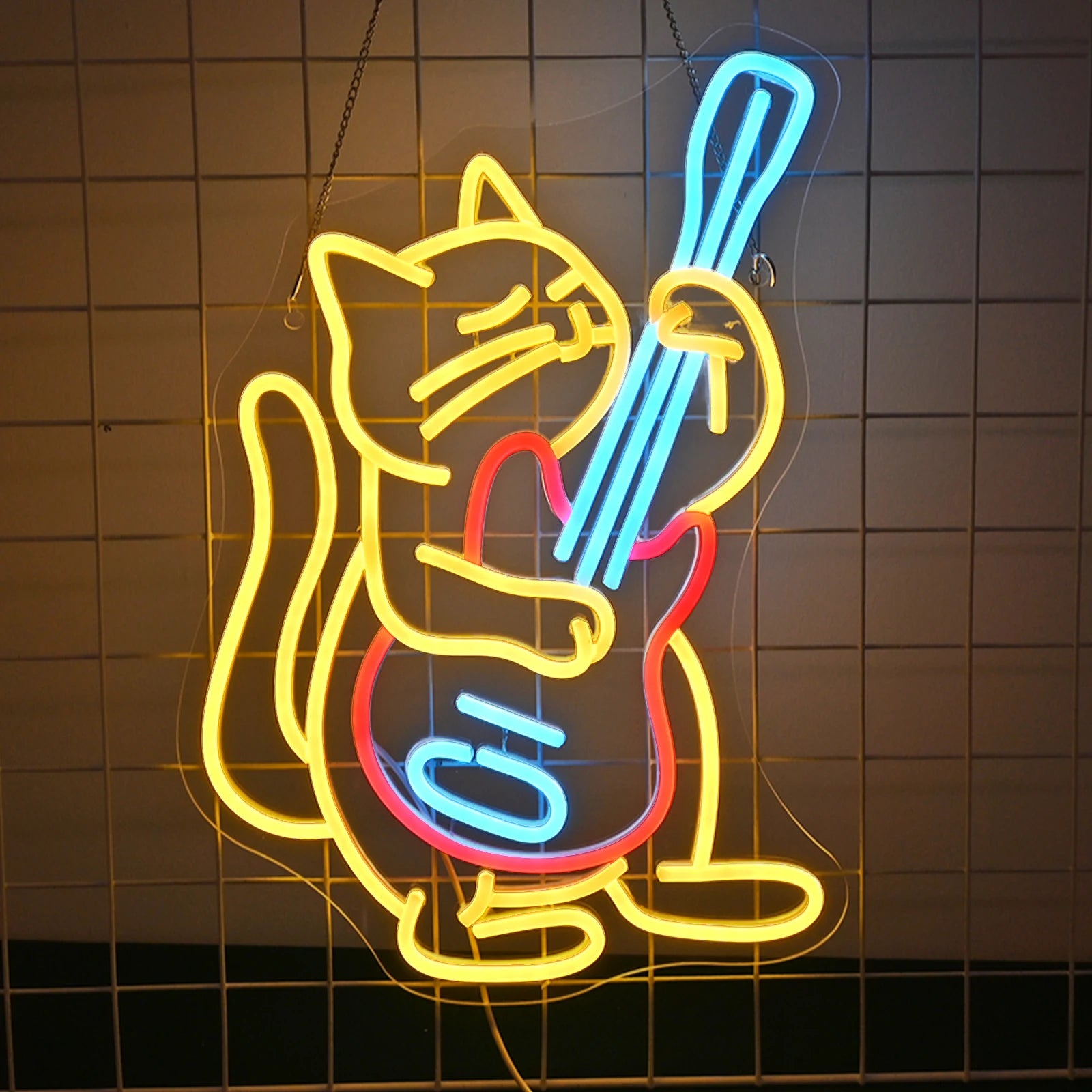 "An LED neon sign features a cartoon-style cat energetically playing an electric guitar.