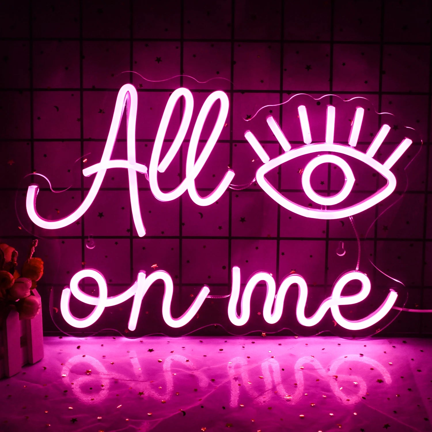 The image features a vibrant LED neon sign that spells out "All Eyes on Me" in a bold script font.