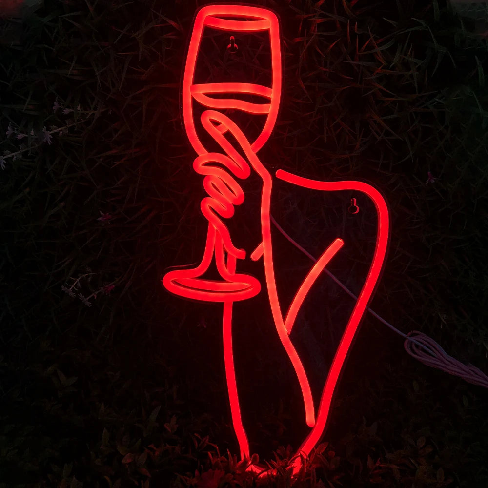 Bilden visar en levande LED-neonskylt som visar en kontur av en kvinna som håller i ett vinglas.