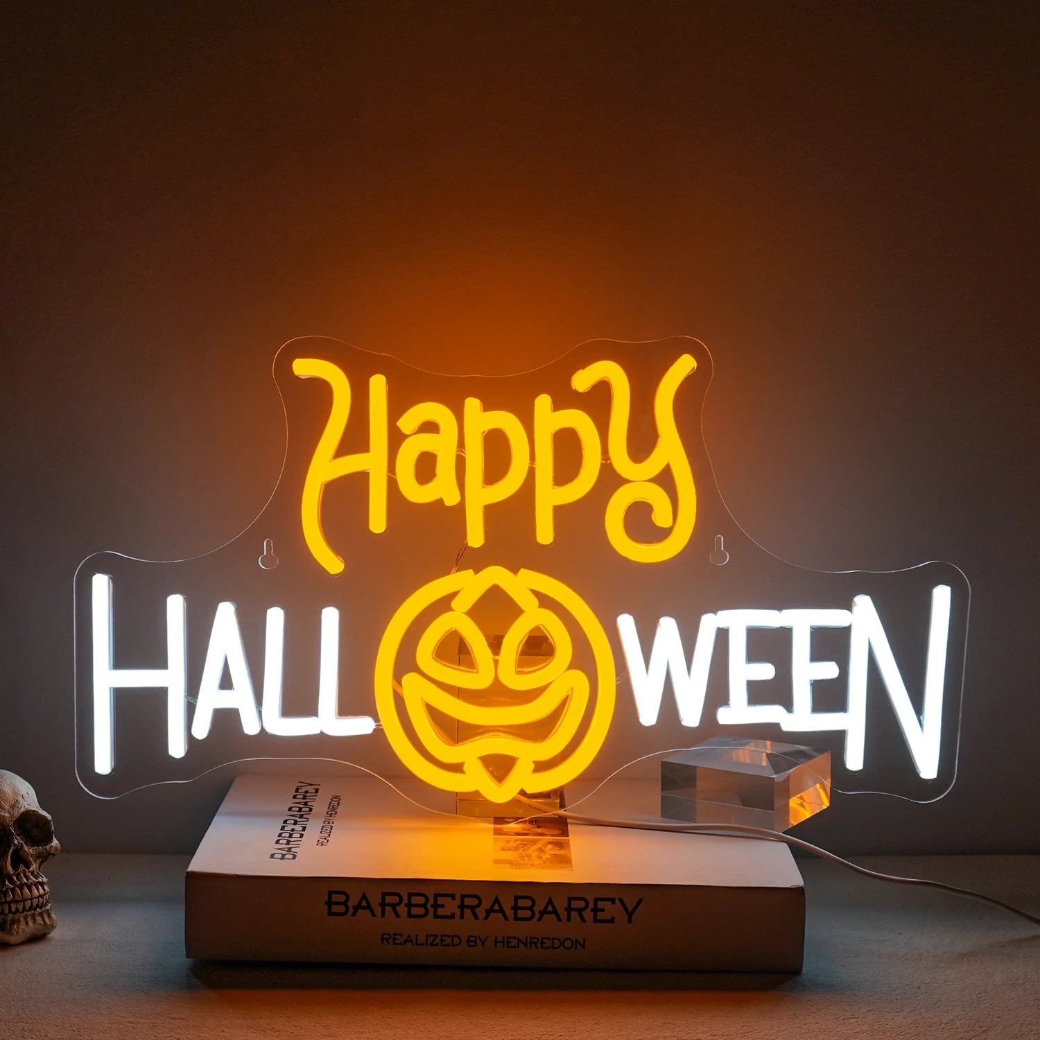 A vibrant LED neon sign displaying the words "Happy Halloween" in a festive font.