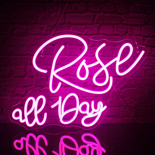 The image features a vibrant LED neon sign displaying the phrase "Rosé All Day" in elegant, cursive lettering.