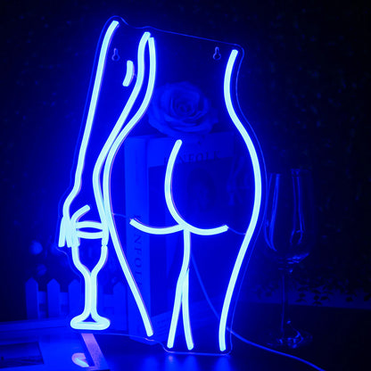 "A vibrant, handmade LED neon sign shaped like a silhouette of a reclining woman.