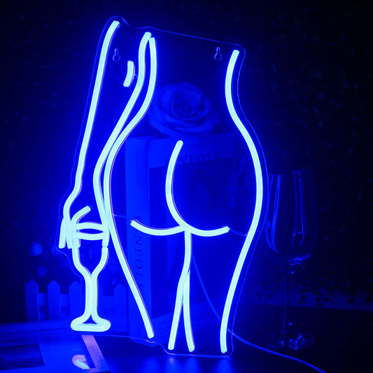 "A vibrant, handmade LED neon sign shaped like a silhouette of a reclining woman.