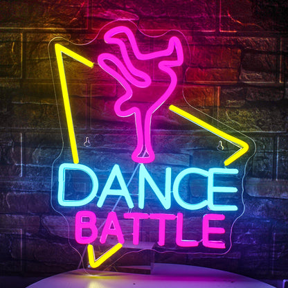 The image features a vibrant LED neon sign with the phrase "Dance Battle" prominently displayed.