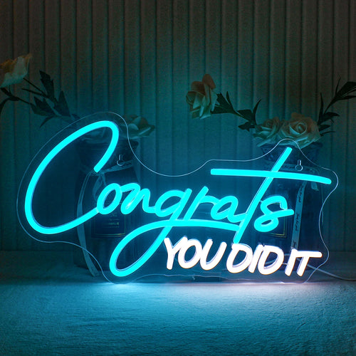 Bilden har en levande LED-neonskylt med texten "Congrats You Did It" i ett lekfullt och stilrent handskrivet typsnitt.
