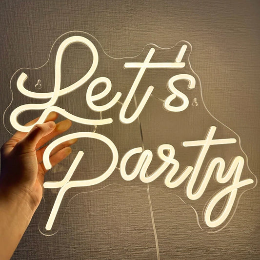 A vibrant LED neon sign displaying the words "Let's Party" in bold, cursive lettering.