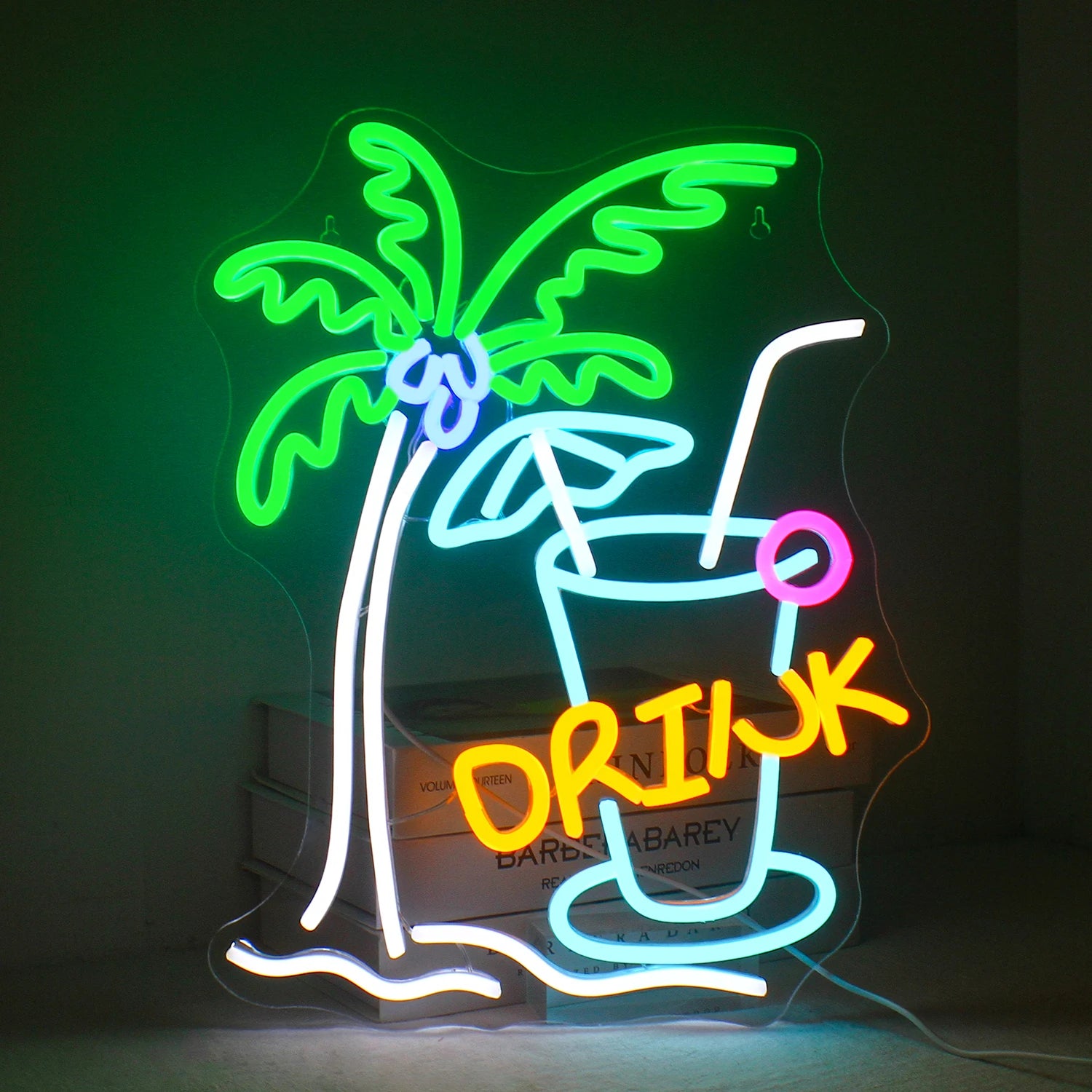 The image features a vibrant LED neon sign shaped like a tropical beach drink.