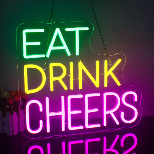 The image displays a vibrant and colorful LED neon sign with three lines of text.