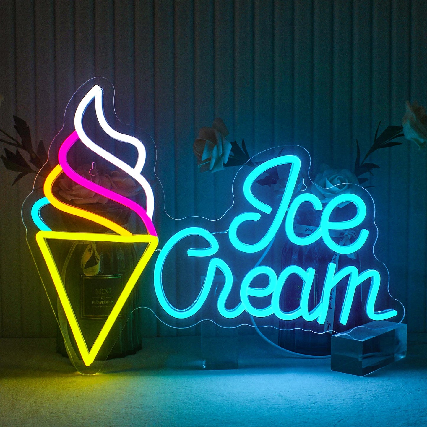 The image features a vibrant LED neon sign shaped like an ice cream cone.
