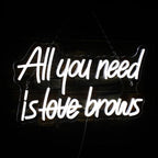 Bilden visar en livlig "All you need is brows" LED neonskylt.