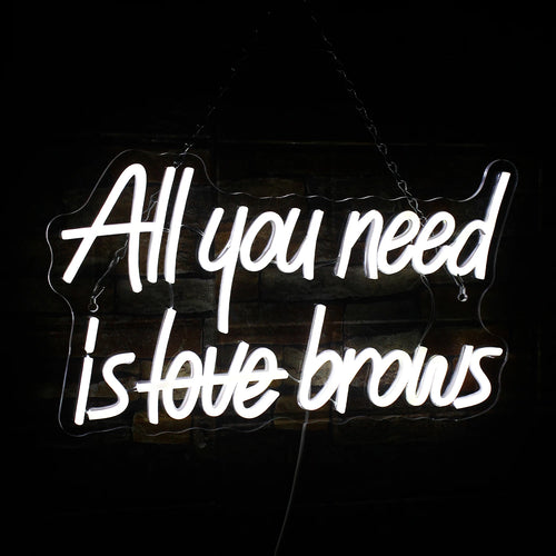 Bilden visar en livlig "All you need is brows" LED neonskylt.